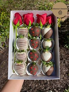 a box filled with chocolate covered strawberries and roses