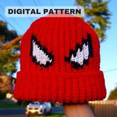 a person wearing a red knitted hat with eyes on it and the words digital pattern above them