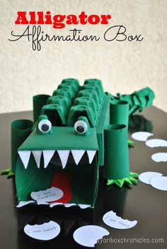 an alligator paper craft with the words alligator affirmation box in front of it