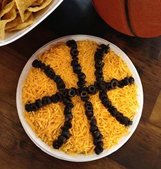 two plates with chips and cheese on them next to a basketball