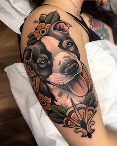 a woman with a dog tattoo on her arm