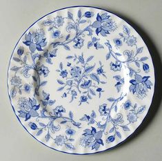 a blue and white plate with flowers on it