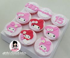 hello kitty cupcakes with pink and white frosting are arranged on a tray