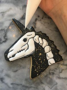 a cookie shaped like a horse has been decorated with icing and sprinkles