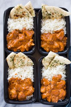 four black trays filled with rice and different types of food on top of each other