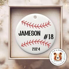 a personalized baseball ornament in a box with a bear on the front