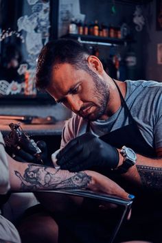 a tattooed man getting his tattoo done