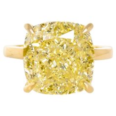 This solitaire ring is a masterpiece of craftsmanship, created by the renowned Antinori Di Sanpietro. It features a magnificent 4-carat cushion cut diamond, boasting a Fancy Intense Yellow color and a clarity grade of VS. This exceptional gemstone is certified by the Gemological Institute of America (GIA), ensuring its quality and authenticity. The diamond is expertly set in a luxurious band made of 18 carats yellow gold, which complements its radiant yellow hue. The ring's design is both timele Tiffany Diamond Ring, Fancy Yellow Diamond Ring, Cushion Diamond Ring, Brilliant Cut Diamond Ring, Yellow Cushion, Cushion Cut Diamond Ring, Sapphire Solitaire Ring, Yellow Cushions, Platinum Diamond Engagement Rings