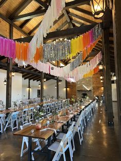 the tables are set up with colorful streamers hanging from the ceiling