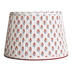 a white lamp shade with red flowers on it