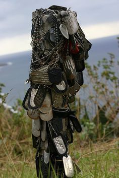 there is a sculpture made out of shoes in the grass