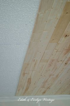 an unfinished ceiling with white paint and wood planks