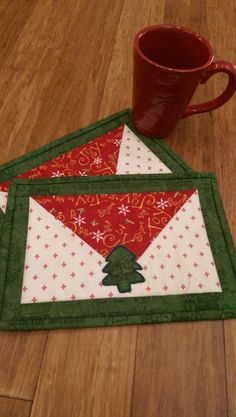 two mug mats with christmas trees on them