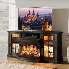 a flat screen tv sitting on top of a wooden cabinet next to a fire place