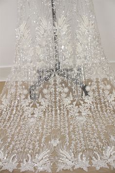 This Stunning Luxury High quality Embroidered Lace Fabric design piece has soft hand feel, ideal for use in DIY craft projects, wedding dress, clothing, party dress, dolls outfits, curtains, shams, lamp shades, headpieces, costumes, accessories, Apparel, handcraft Accessory, cake decor, unity candle, garters, headbands, dance costumes, belly dance costumes. --- THE DETAILS --- This listing is for 1 yard embroidery lace fabric. Wide: about 51inch/130cm Colors: off-white Material: Polyester, Trans Wedding Sequined Embroidered Floor-length Fabric, Wedding Embroidered Sequins Floor-length Fabric, Floor-length Embroidered Fabric With Sequins For Wedding, Floor-length Embroidered Wedding Fabric With Sequins, Wedding Floor-length Embroidered Fabric With Sequins, White Beaded Tulle Fabric For Wedding, White Embellished Embroidered Fabric For Banquet, Floor-length Embellished Sequin Fabric For Weddings, White Sequined Wedding Dress For Banquet