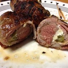 two pieces of meat sitting on top of a white plate