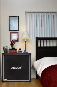 a bed room with a neatly made bed and a nightstand