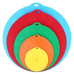 four colorful cutting boards stacked on top of each other in the shape of a circle