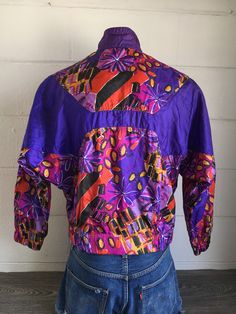 Get wild and whacky in this 90's gem! It screams hip hop, street style, and funky fun! There is a small mark on the sleeve (see pic) otherwise mint condition. Check out other sensational vintage Nike gear in my shop https://www.etsy.com/shop/sweetVTGtshirt?section_id=11916484&ref=shopsection_leftnav_4 Label: Nike Measurements (inches): Chest/Bust: 24 Bottom hem: 19 (unstretched) Sleeve (from collar): 28 1/2 Total length from shoulder to bottom seam: 24 1/2 Size: Tag reads Small. See measurem Vintage Purple Windbreaker For Streetwear, Vintage Windbreaker For Fall Sports, Retro Purple Windbreaker For Streetwear, Retro Track Jacket For Spring Sports, Retro Spring Track Jacket For Sports, Vintage Spring Sports Windbreaker, Nike Air Jacket, Hip Hop Street Style, Grunge Tee