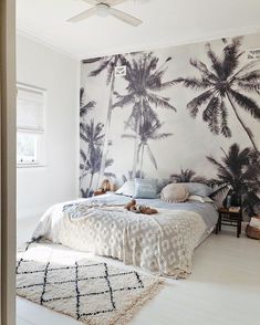 the instagram page shows an image of a bedroom with palm trees on the wall