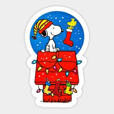 a sticker depicting a snoopy dog on top of a christmas present