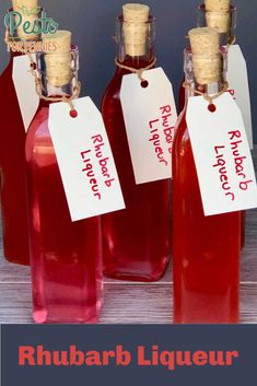 three bottles of rhubarb liqueur with labels on them and the words rhubarb liqueur written in red