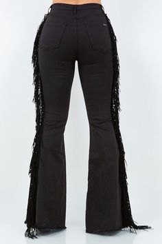 Introducing our Texas Sun Bell Bottom Jean, the perfect addition to your wardrobe for making a statement. These jeans feature a high-rise fit and a unique side tassel fringe detail, adding a touch of western flair to your look. Made in the USA, these jeans are both stylish and functional with front and back pockets, a button and zipper closure, and a frayed hem. The fabric is a comfortable blend of 59% cotton, 32% tencil, 6% polyester, and 3% lycra, making them stretchy and non-sheer. To keep th Black Bell Bottoms Outfit Western, Black Stretch Fringe Bottoms, Bell Bottom Jeans Black, Gothic Bell Bottom Outfit, Gothic Bell Bottoms, Texas Sun, Lace Side, Biker Shirts, Bottom Jeans