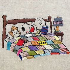 the peanuts are sleeping in bed together on their own pillow and blanket, which is decorated with an image of snoop's birthday cake