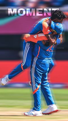 two men in blue and orange uniforms hugging each other on a field with the words moment written above them