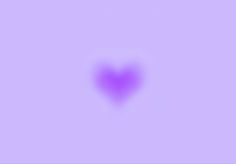 a heart shaped object in the middle of a purple sky with no one around it