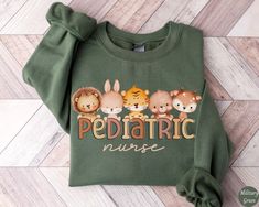 Cute Pediatric Nurse Sweatshirt, Pediatric Nurse Shirt, Pediatric Nurse Gift, Nurse Appreciation Gift, Cozy Peds Nurse Sweater ✧ SIZING ✧ ⋒ Please check our size chart before placing an order. ⋒ If you want an oversized look, pick a sweatshirt that is 2 sizes larger than your usual size. ✧ IMPORTANT NOTE: We try to depict all shirt and design colors as close to the original as possible but depending on your screen settings or the shirt color you chose, the colors of the graphics may vary slightl Cute Green Sweatshirt With Letter Print, Bliss Products, Nursing Hoodie, Nursing Accessories, Nurse Appreciation Gifts, Nurse Sweatshirt, Pediatric Nursing, Crew Shirt, Sweater Design