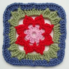 a crocheted square with a flower in the center