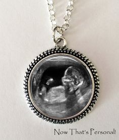 a necklace with an image of a baby in the center