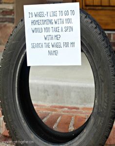 a sign on a tire that says to wheel - i like to go to homecoping with you would you take a spin with me? search the wheel for my name