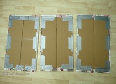 three pieces of cardboard sitting on top of a wooden floor