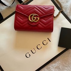 The Gg Marmont Chain Bag Has A Softly Structured Shape And A Flap Closure With Double G Hardware. Made In Matelasse Chevron Leather. Gucci Red Evening Bag, Red Gucci Evening Bag, Designer Shoulder Bag With Chain Strap As Gift, Red Gucci Bag With Chain Strap, High-end Red Shoulder Bag For Gift, Gucci Party Bags With Gold-tone Hardware, Gold Gucci Party Bag, Gucci Bags With Chain Strap For Gift, Gucci Bags As Gifts