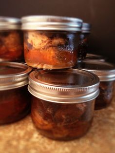 several jars filled with food sitting on top of a table