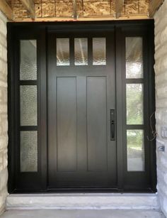 a black front door with glass panels