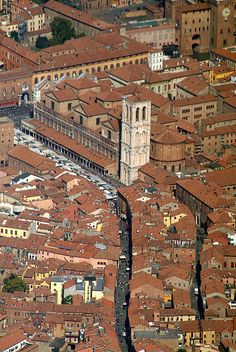 an aerial view of a city with tall buildings and lots of red bricked roofs