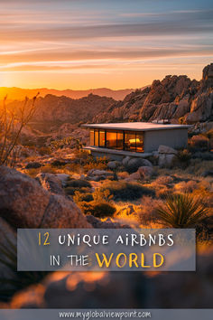 A modern, minimalist Airbnb cabin with large glass windows overlooking a rugged desert landscape at sunset. Warm golden light glows from the interior, surrounded by rocky terrain and desert vegetation, creating a tranquil and luxurious retreat.