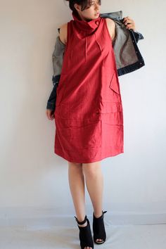 "100% Cotton. The fabric has a great texture. An adapted version of our popular tulip dress. An elegant sleeveless dress, full of small detail. Pleated detailed front. Turtle neck collar that can also be folded down (see picture 2 for this style). Gathers from the side to the bottom which creates volume. 2 side pockets/hand warmer. Line of buttons on the back of the collar. This piece is perfect for layering over long sleeves. Wear it alone, with leggings, with a cardigan or suit shirt. etc. You Knee-length Shift Midi Dress With Pockets, Shift Midi Dress With Pockets, Knee-length, Knee-length Sleeveless Dress With Pockets For Work, Sleeveless Workwear Dresses With Slip Pockets, Sleeveless Shift Midi Dress For Work, Red Shift Midi Dress Knee-length, Fitted Sleeveless Knee-length Dress With Pockets, Sleeveless Linen Dress With Pockets For Work, Red Sleeveless Dress With Pockets