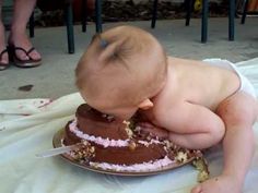 a baby laying on top of a cake with the caption babies bring us joy