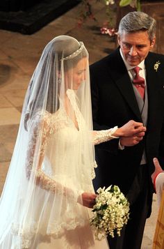 the bride and groom are walking down the aisle at their wedding ceremony in black and white