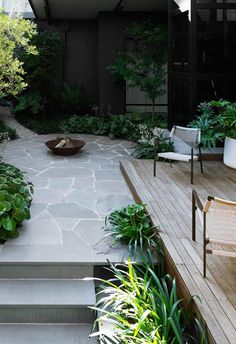 an outdoor patio with stone steps and plants