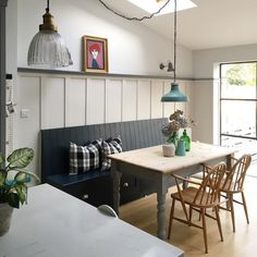 a dining room table and bench in front of a window with the words periodhome on it