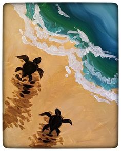 two turtles walking on the beach towards the ocean