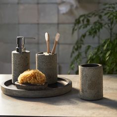 a bathroom set with soap dispenser and toothbrush holder