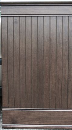 a brown wooden cabinet sitting on top of a sidewalk