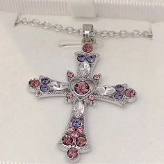 This Stunning Necklace Features A Beautiful Pink Cross Pendant Adorned With Sparkling Cubic Zirconia Stones. The Necklace Is Perfect For Fashion-Forward Women Who Want To Add A Touch Of Elegance And Style To Their Outfit. The Pendant Is Set On A Delicate Chain With A Secure Clasp That Keeps It In Place All Day Long. The Necklace Is 18 Inches Long With An Adjustable Chain 2 Inches Additionally. E128 Pink Cross Sterling Silver Jewelry, Cross Necklace Pink, Elegant Cross-shaped Rhinestone Necklace For Parties, Cheap Pink Cross-shaped Jewelry, Adjustable Pink Cross-shaped Jewelry, Pink Cross, Bracelets Silver, Delicate Chain, Cross Pendant Necklace