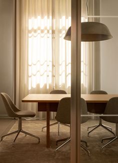 a table and chairs in front of a window